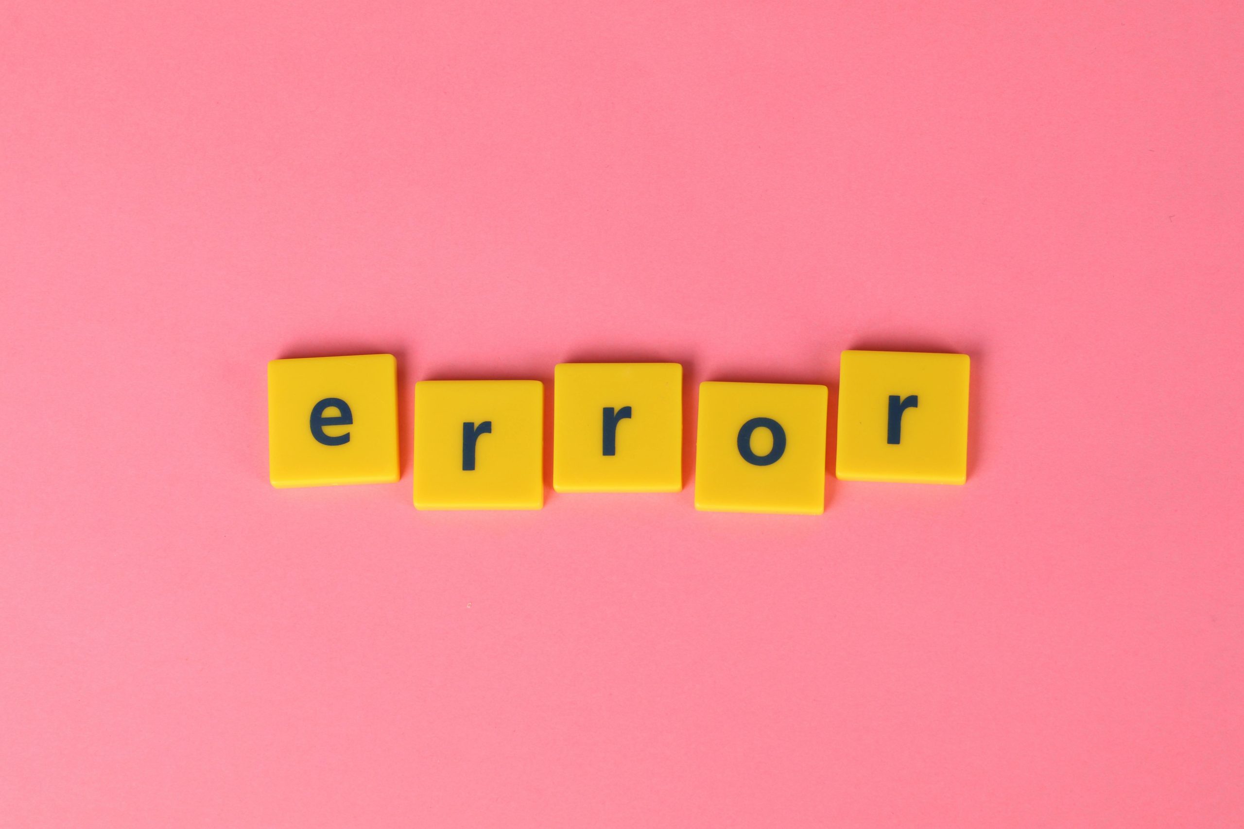 Yellow block letters spelling 'error' on a vibrant pink background, capturing a playful message.